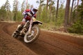 Motocross driver accelerating the motorbike on the race track Royalty Free Stock Photo