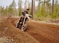 Motocross driver accelerating the motorbike on the race track Royalty Free Stock Photo
