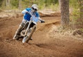 Motocross driver accelerating the motorbike on the race track