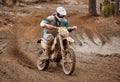 Motocross driver accelerating the motorbike on the race track Royalty Free Stock Photo