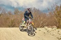 Motocross driver in action accelerating the motorbike after the corner on the race track Royalty Free Stock Photo