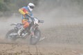 Motocross driver in dust