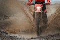 Motocross driver splashing mud