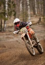 Motocross enduro driver accelerating the motorbike on the race track