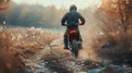 Motocross. Man, professional motorcyclist in full moto equipment riding crops enduro bike on mountain road at sunset