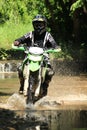 Motocross men, Enduro ride through water splashing in canals,