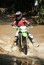 Motocross men, Enduro ride through water splashing in canals,