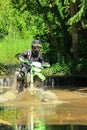 Motocross men, Enduro ride through water splashing in canals,