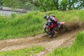 Motocross. Motorcyclist in a bend rushes along a dirt road, dirt flies from under the wheels.