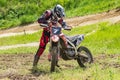 Motocross. Motorcyclist prepares to continue the race after a slight fall. Close-up.