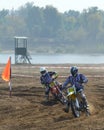 Motocross: motorcyclists pass a turn Royalty Free Stock Photo