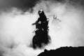 Motocross racer accelerating in dust track