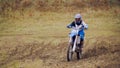 Motocross racer on dirt bike at sport track - fast and danger