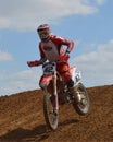 Motocross: racer in red Royalty Free Stock Photo