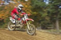 Motocross racer in red id riding