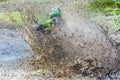 Motocross racer rides through the mud with big splash, Royalty Free Stock Photo