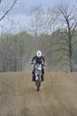 Motocross Racer Riding Down a Dirt Hill Royalty Free Stock Photo