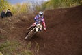 Motocross racer turns with large slope Royalty Free Stock Photo