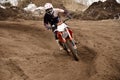 Motocross racing driver at turning Royalty Free Stock Photo