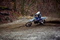 Motocross rider in action accelerating the motorbike after the corner on the race track Royalty Free Stock Photo