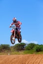 Motocross rider and bike clearing a tabletop jump Royalty Free Stock Photo