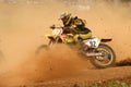 Motocross rider in curve with dust in the face Royalty Free Stock Photo