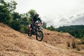 Motocross rider on his bike ready to race in dirt track Royalty Free Stock Photo