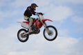 Motocross rider jump, blue sky