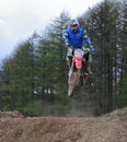 Motocross rider jumping a rise Royalty Free Stock Photo