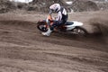 Motocross rider veering point-blank of sand with Royalty Free Stock Photo