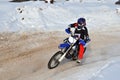 Motocross on snow racer on a motorcycle in the left turn having Royalty Free Stock Photo