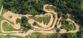 Motocross track in the middle of a green countryside. Horizontal drone shot.