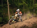 Motocyclist rides through the forest Royalty Free Stock Photo