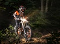 Motocyclist rides through the forest Royalty Free Stock Photo