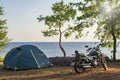 Motor bike and tent at the sea coast Royalty Free Stock Photo