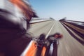 Motor biker in action on an empty road-Outdoors adventures and freedom concept.Motorcycle trip