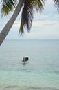 A small motor boat anchored in shallow tropical waters. Royalty Free Stock Photo