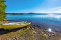 The motor boat in the border of Siebdniesjavrrie lake Swedish Lapland. The sun is reflecting in the water. Vasterbotten county,