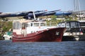 Motor boat with brown hull and white deckhouse on a sunny day