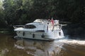 Motor boat cruising on a British canal the Aire and Calder navigation