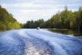 Motor boat floating on a forest river, front view, Sunny day Royalty Free Stock Photo