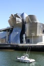 Motor boat past the Guggenheim Museum Royalty Free Stock Photo