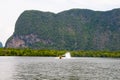 Motor boat on a rock background