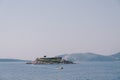Motor boat sails along the Kotor Bay from the island of Mamula. Montenegro