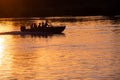 A motor boat sails on the river at sunset