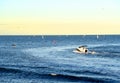 Motor boat in the sea at sunset. Yacht and motorboat on waves in Mediterranean Sea. Skiff and Sailboat in ocean.