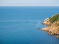 Motor boat on the surface of the sea near the island.