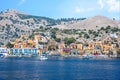 Motor boats and colorful houses in harbor town of Symi Symi Island, Greece