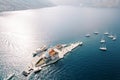 Motor boats and sailboats are moored around the island of Gospa od Skrpjela. Montenegro. Drone Royalty Free Stock Photo
