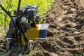 Motor cultivator making fresh raw in garden soil Royalty Free Stock Photo